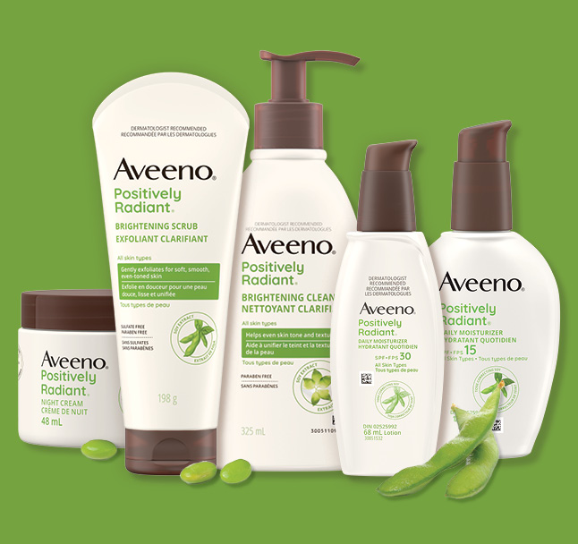 Five Aveeno® Positively Radiant Skin Care Products and soy beans.